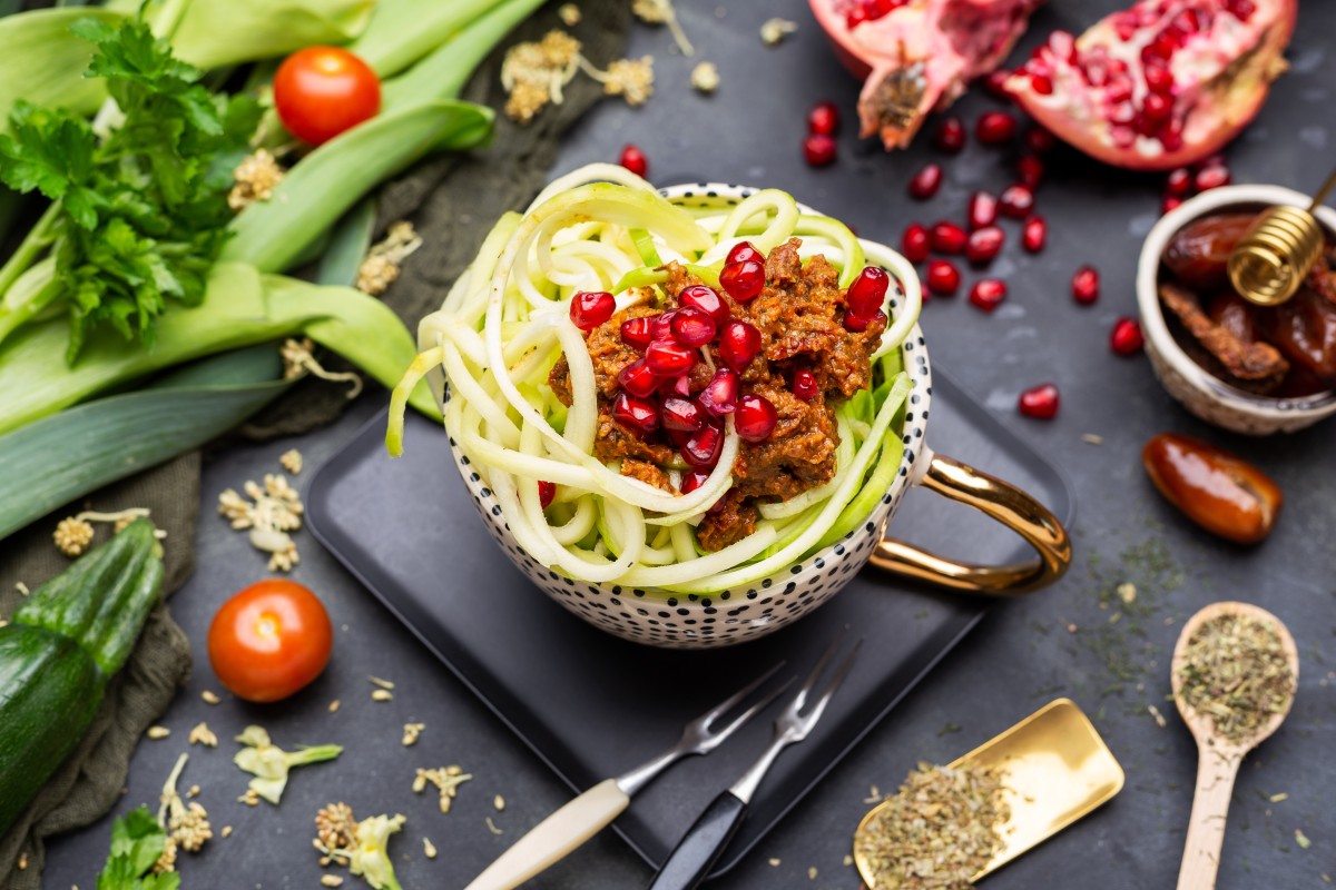 top-view-vegan-meal-with-spiralized-zucchini-tomato-sauce-pomegranates-cup (1)